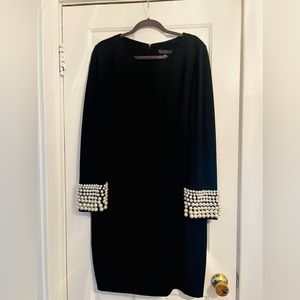 Black cocktail dress with pearl cuffs.